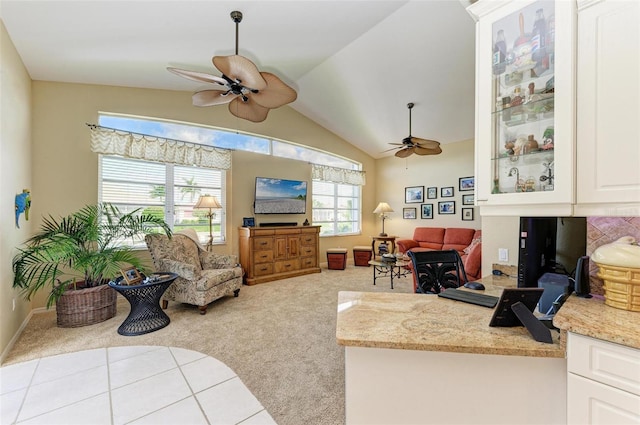 carpeted living room featuring vaulted ceiling and ceiling fan