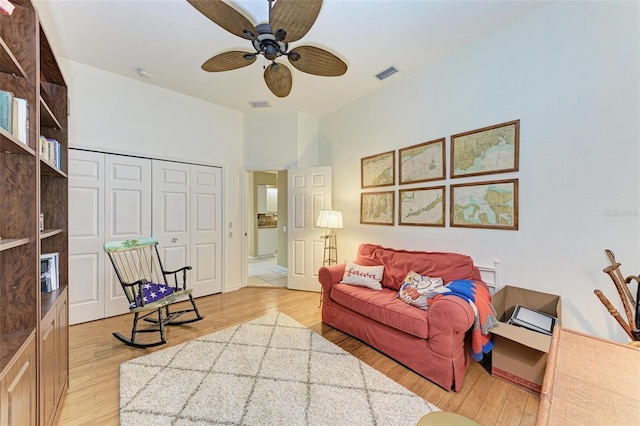 living room with light hardwood / wood-style flooring and ceiling fan