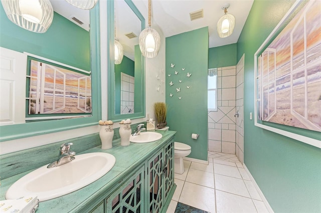 bathroom with tile patterned flooring, vanity, and toilet