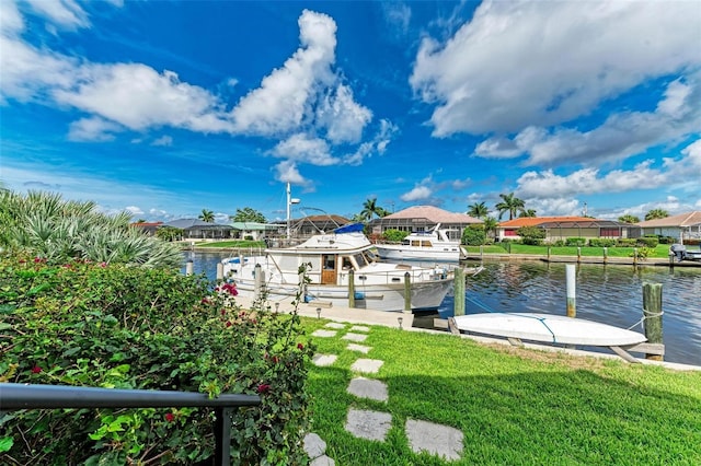 dock area with a yard and a water view