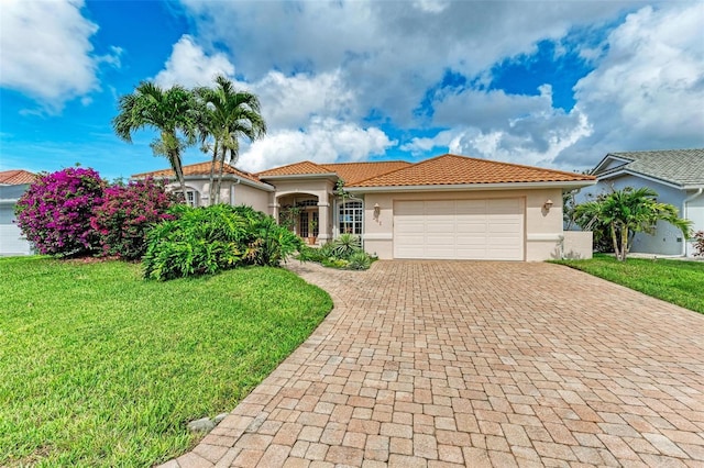 mediterranean / spanish-style home with a front lawn and a garage