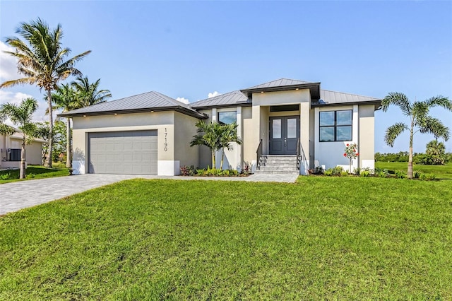 view of front of property with a garage and a front lawn