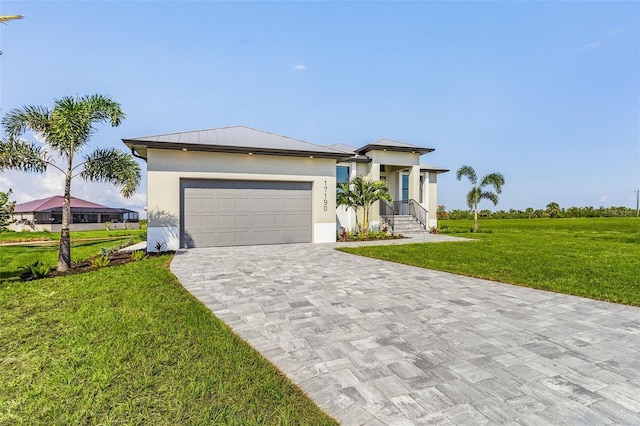 view of front of home with a front lawn and a garage