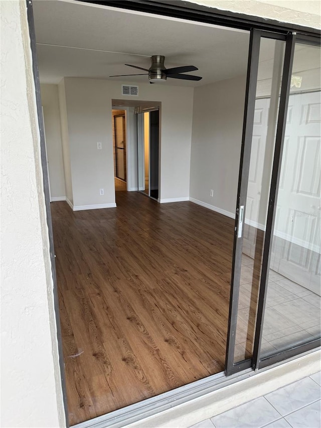 unfurnished room featuring ceiling fan and wood-type flooring