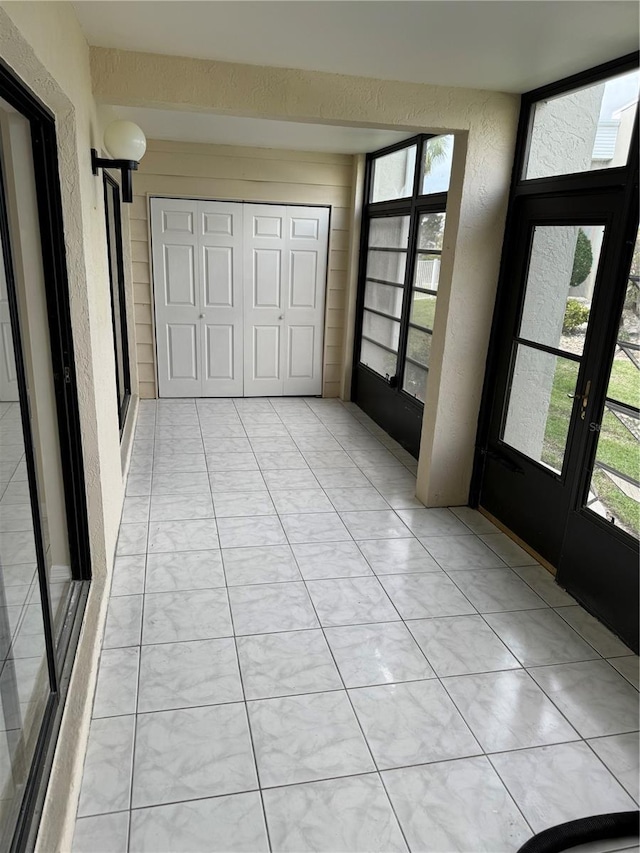 interior space featuring plenty of natural light and light tile patterned flooring