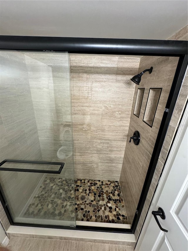 bathroom featuring an enclosed shower