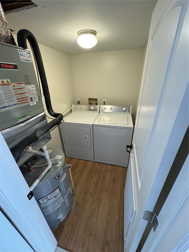 washroom with washing machine and dryer and dark hardwood / wood-style floors