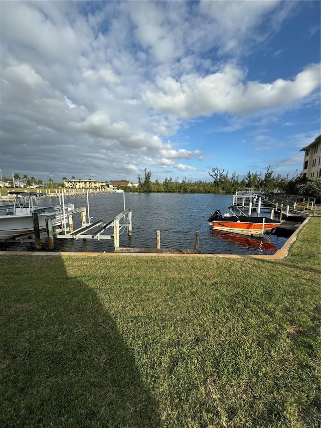 view of dock featuring a yard and a water view