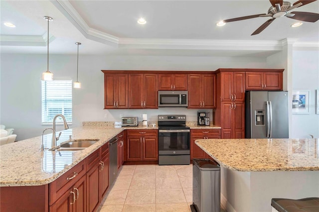 kitchen featuring sink, kitchen peninsula, pendant lighting, a kitchen bar, and appliances with stainless steel finishes