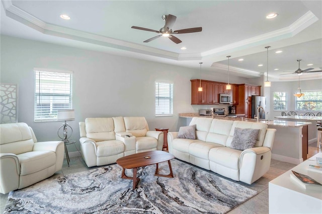 living room with a raised ceiling and a wealth of natural light