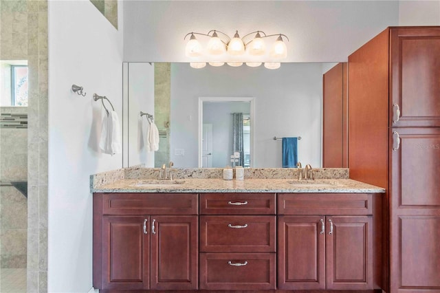 bathroom featuring a tile shower and vanity