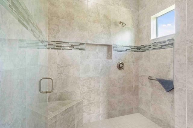 bathroom with a shower with door