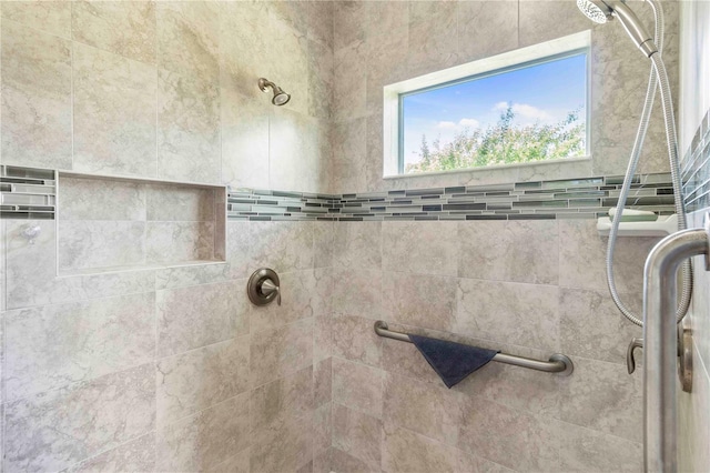 bathroom with tiled shower