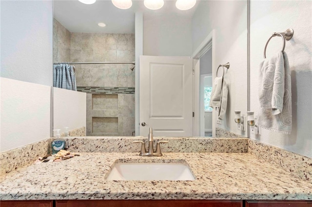 bathroom featuring vanity and a shower with shower curtain