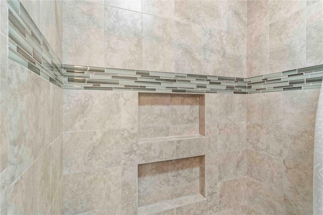 interior details with a tile shower