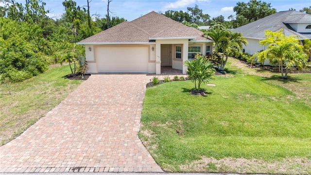 view of front of house featuring a front yard and a garage