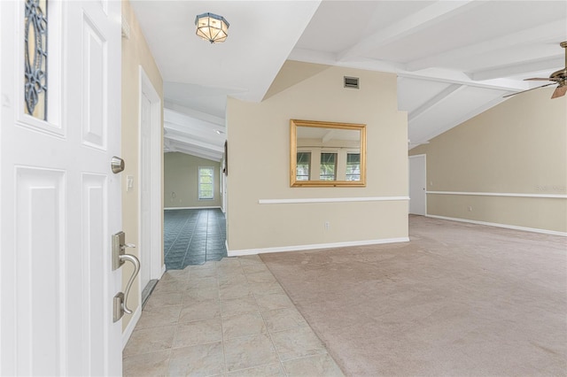 interior space featuring lofted ceiling with beams, ceiling fan, and light tile patterned floors