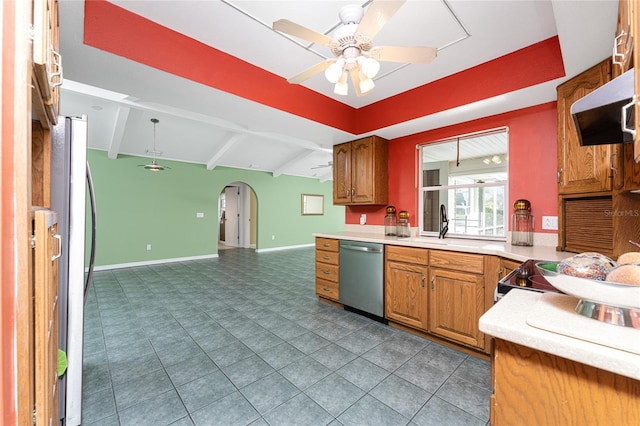 kitchen with beam ceiling, ceiling fan, sink, stainless steel appliances, and extractor fan