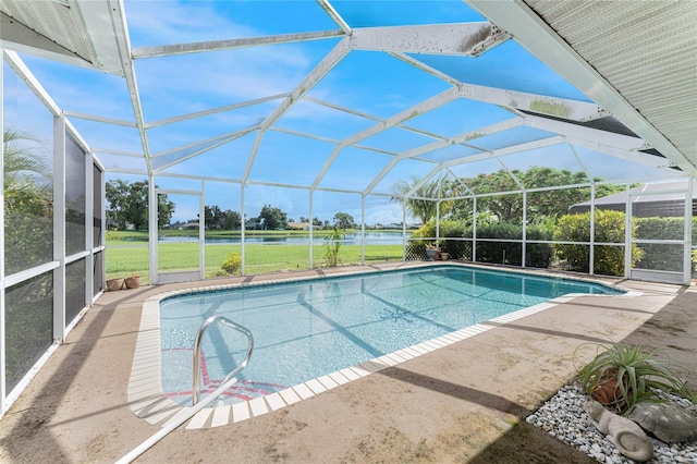 view of swimming pool with a lawn, glass enclosure, a patio area, and a water view