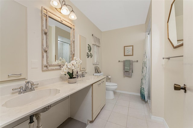 bathroom featuring toilet, tile patterned floors, and sink