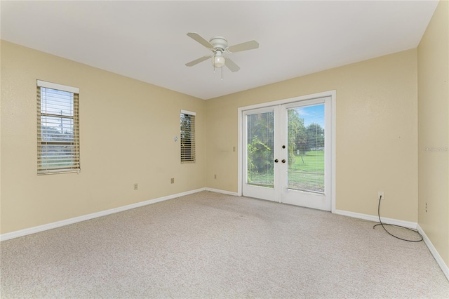 unfurnished room featuring ceiling fan, french doors, and carpet floors