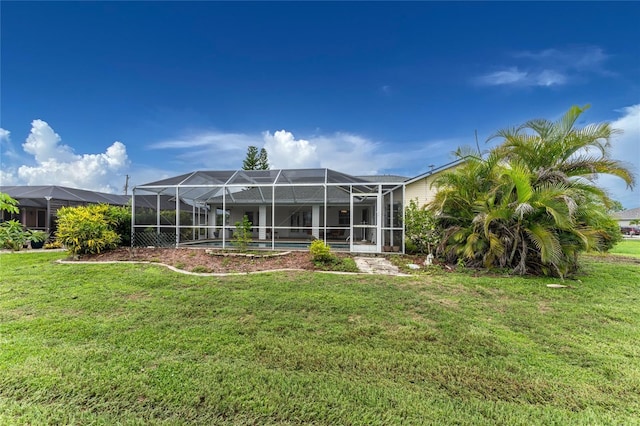 rear view of property featuring a lawn and glass enclosure