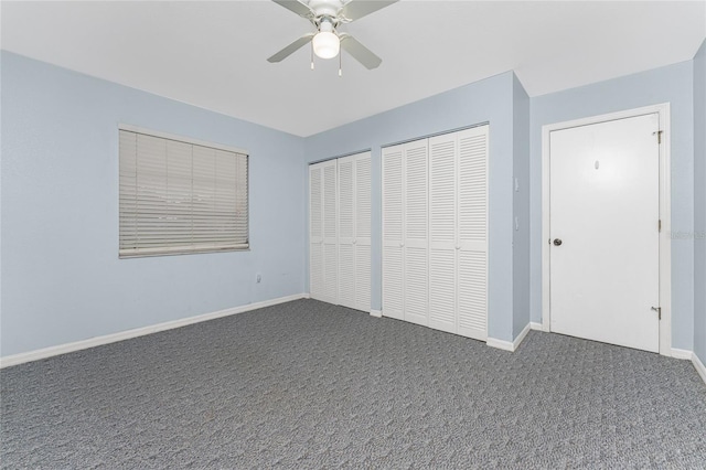 unfurnished bedroom with ceiling fan, carpet floors, and two closets