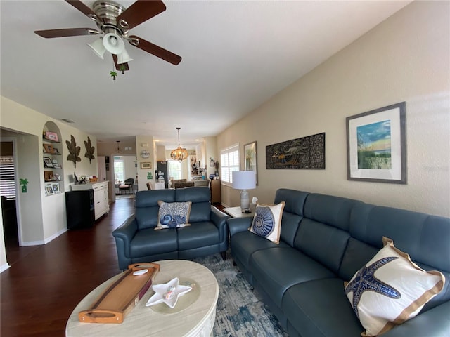 living room with dark hardwood / wood-style floors and ceiling fan