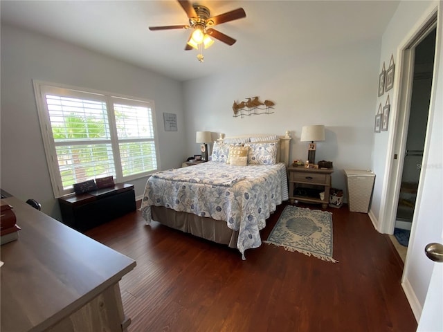 bedroom with dark hardwood / wood-style floors and ceiling fan