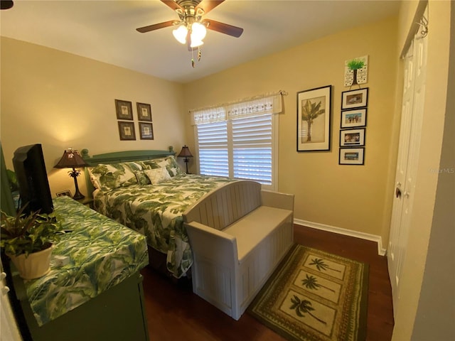 bedroom with ceiling fan, a closet, and dark wood-type flooring