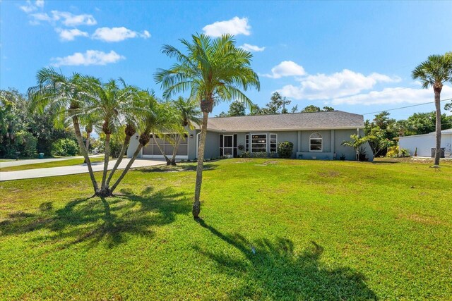 ranch-style home with a garage and a front yard