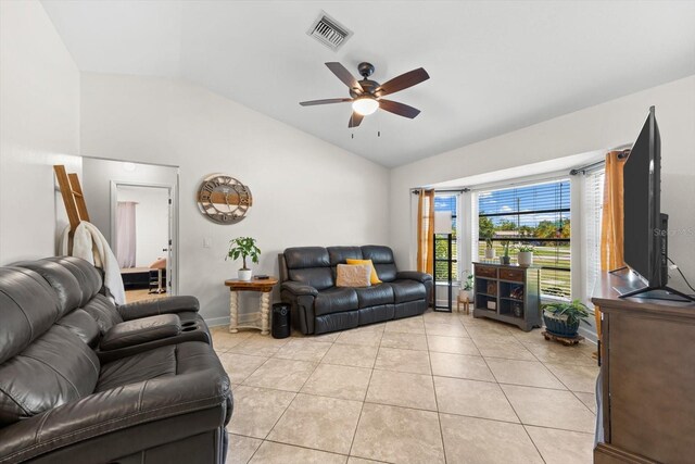 tiled living room featuring ceiling fan and vaulted ceiling