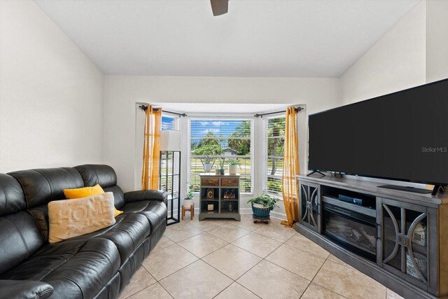 tiled living room with ceiling fan