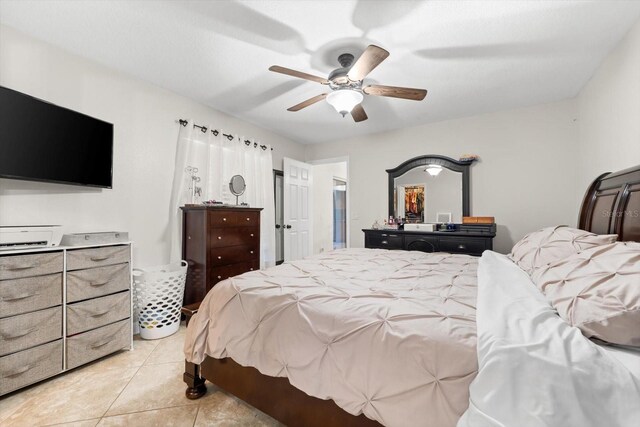 tiled bedroom featuring ceiling fan