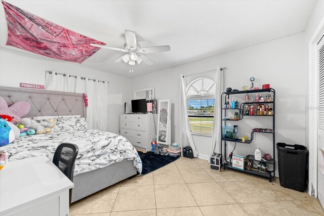 tiled bedroom with a closet and ceiling fan