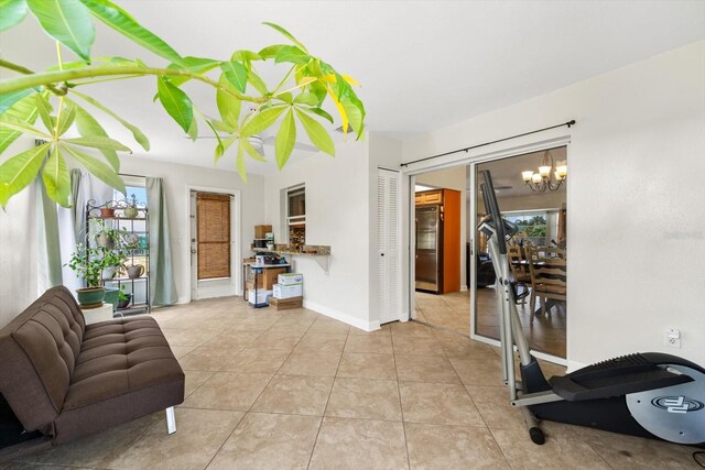 sitting room featuring light tile patterned flooring and an inviting chandelier