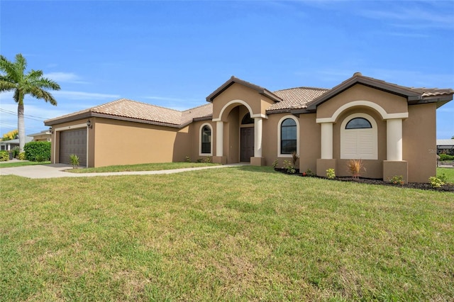 mediterranean / spanish house with a garage and a front lawn