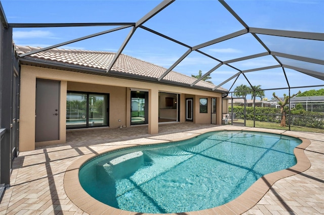 view of swimming pool featuring a patio and a lanai