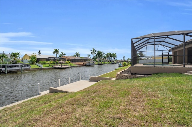 view of dock featuring a lanai, a yard, and a water view