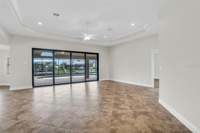 unfurnished room featuring a raised ceiling, ceiling fan, and crown molding