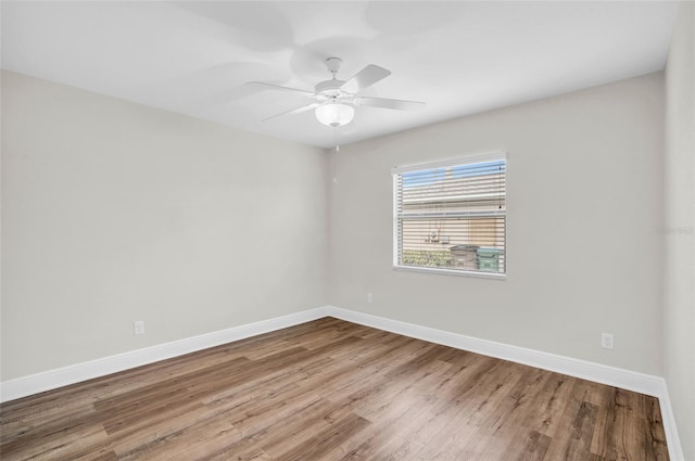 spare room with hardwood / wood-style floors and ceiling fan