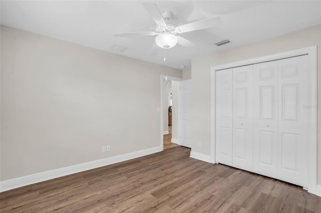 unfurnished bedroom featuring a closet, ceiling fan, and hardwood / wood-style floors