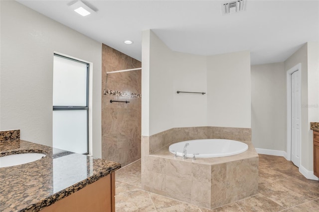 bathroom featuring tile patterned flooring, vanity, and plus walk in shower