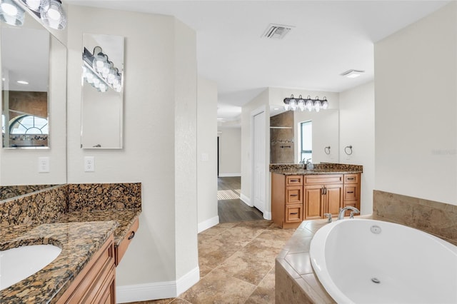 bathroom with shower with separate bathtub and vanity