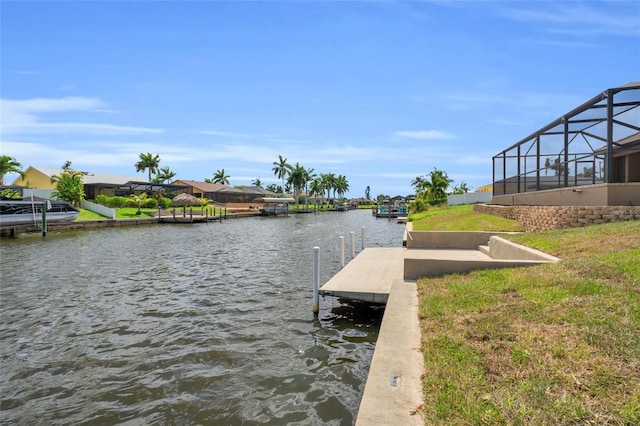 view of dock with a water view and glass enclosure