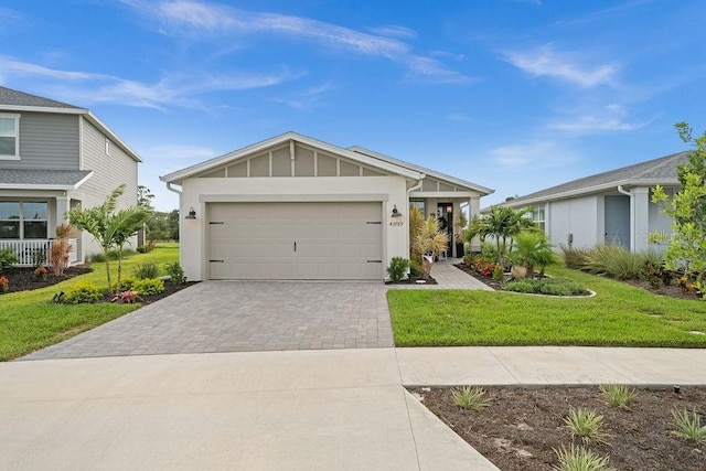 view of front of home with a front yard and a garage