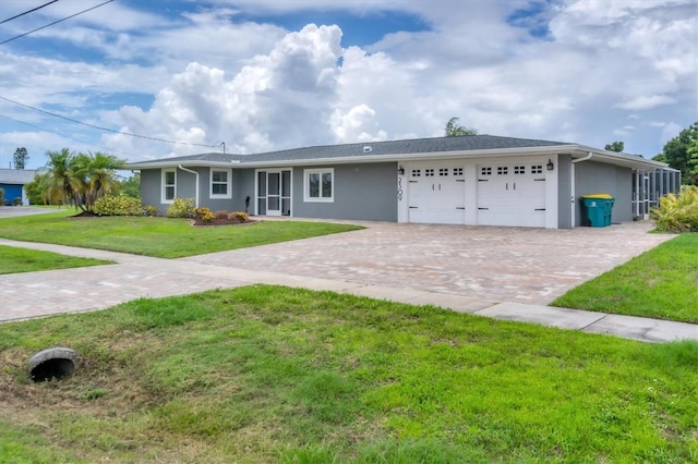 ranch-style home featuring a garage and a front lawn