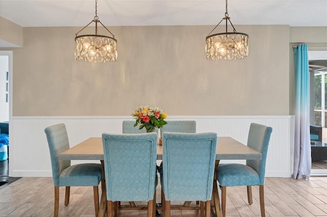 dining room featuring a notable chandelier and light hardwood / wood-style floors