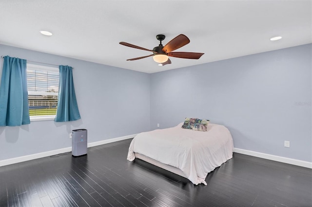 unfurnished bedroom with dark wood-type flooring and ceiling fan