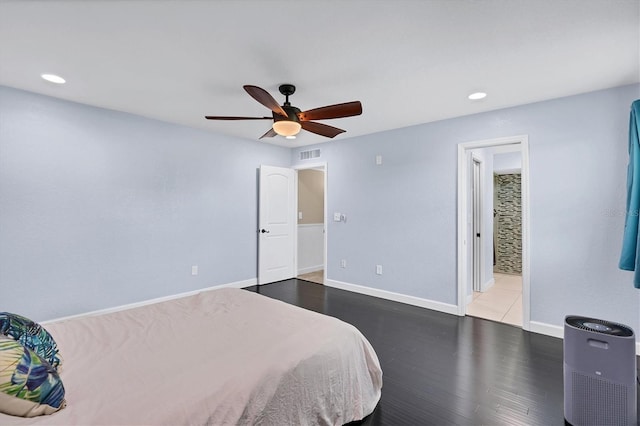 bedroom with ceiling fan, hardwood / wood-style floors, and ensuite bath